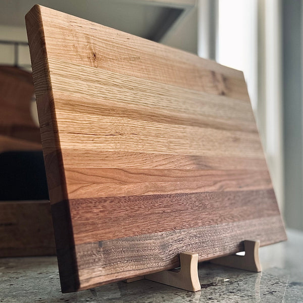 Maple cutting board stand holding an ombré cutting board 