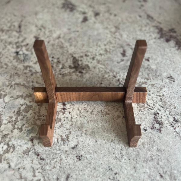 Walnut cutting board stand sitting on a counter