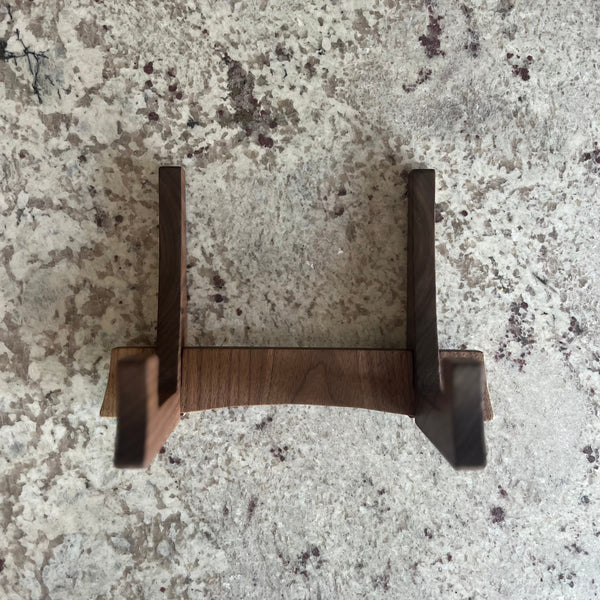 Walnut cutting board stand sitting on a  counter